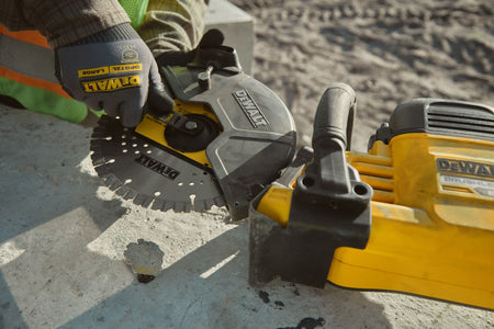 Contractor using the onboard arbor wrench to change the 9-inch diamond wheel on a DeWalt DCS692 cut-off saw.
