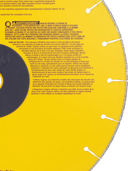 A macro close-up view of the rear side of the DeWalt metal cutting wheel, focusing on the yellow rim expansion slots and extensive French safety warnings and operator instructions printed in white text on the core housing.