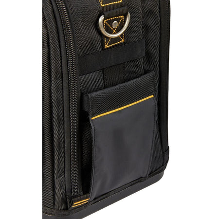 Close-up detailing the side of the black tool bag fabric, featuring a sturdy metal D-ring for the shoulder strap attachment and a closed accessory pocket accented with yellow stitching.