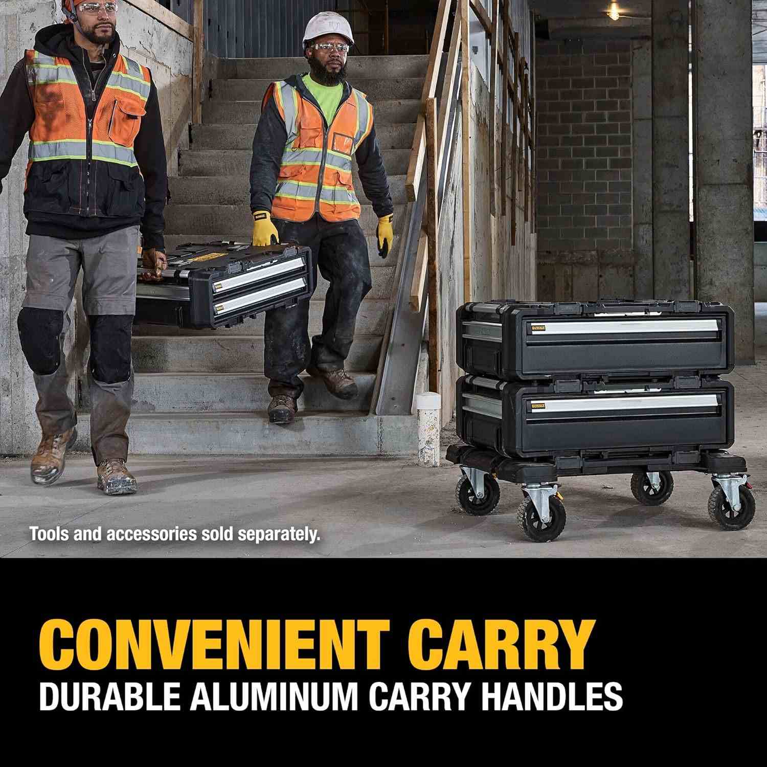 Action shot of two construction workers carrying a stack of two deep drawer units down a flight of concrete stairs using the side handles, captioned Convenient Carry.