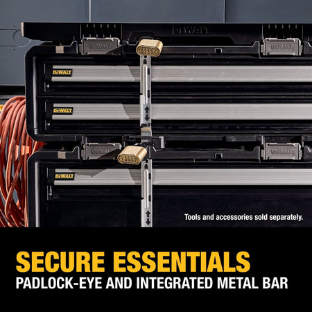 A close-up application graphic demonstrating the locking security of stacked DEWALT tool boxes, showing a central vertical metal locking bar running down the front faces with brass combination padlocks clicked into the top and center padlock-eyes, with lower white text reading SECURE ESSENTIALS PADLOCK-EYE AND INTEGRATED METAL BAR.