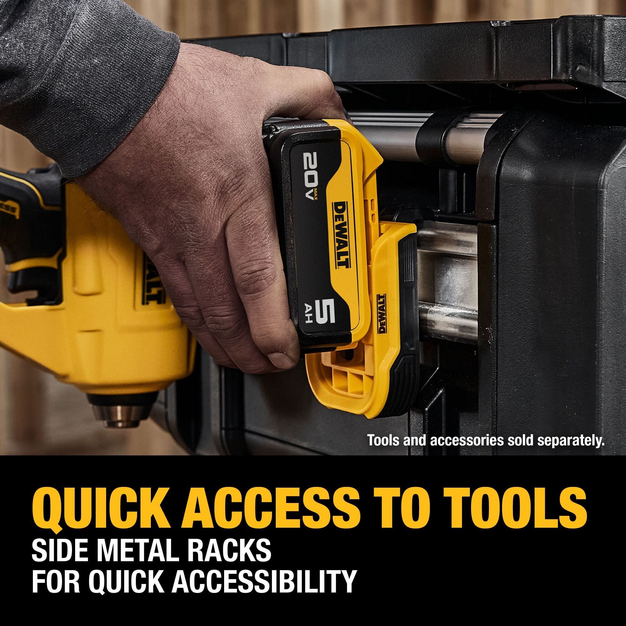 A macro application close-up photo showing a tradesman's hand hanging a yellow and black DEWALT 20V MAX 5 Ah lithium-ion cordless power tool battery pack onto the side metal rack rail of the ToughSystem 2.0 box for rapid jobsite accessibility, with prominent lower text callouts reading QUICK ACCESS TO TOOLS SIDE METAL RACKS FOR QUICK ACCESSIBILITY.