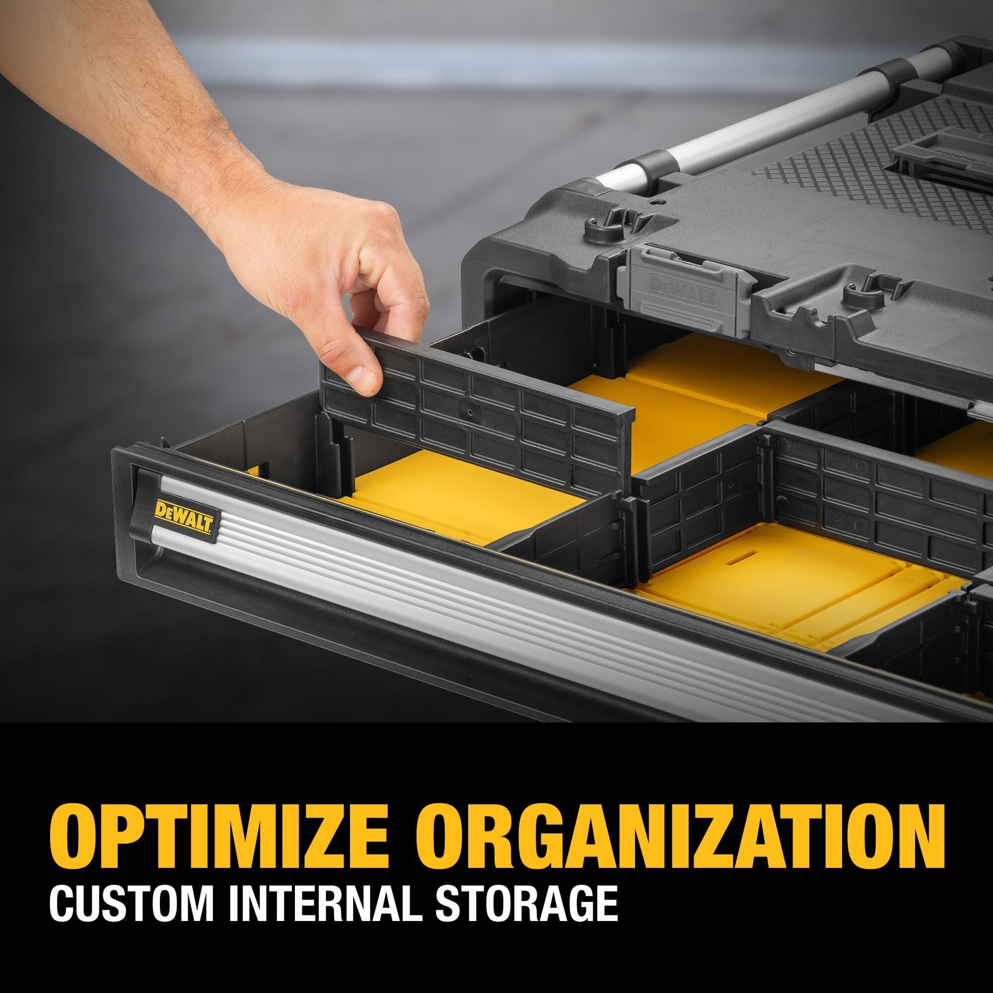 An close-up product marketing graphic of a worker's hand sliding a black plastic space partition into a slot inside the extended yellow tray of the tool chest, accompanied by bold lower yellow and white text stating OPTIMIZE ORGANIZATION CUSTOM INTERNAL STORAGE.