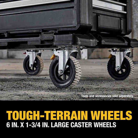Close-up view of the dolly's large caster wheels rolling over rough concrete debris, captioned Tough-Terrain Wheels 6 inch by 1-3/4 inch large caster wheels.