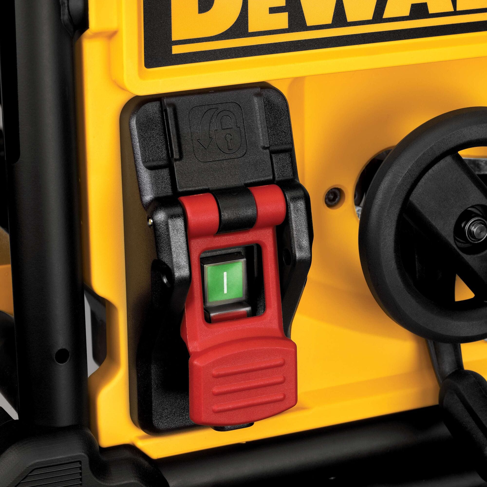Safety power switch with red lockout cover on the DeWalt DWE7491RS jobsite table saw to prevent accidental startup.