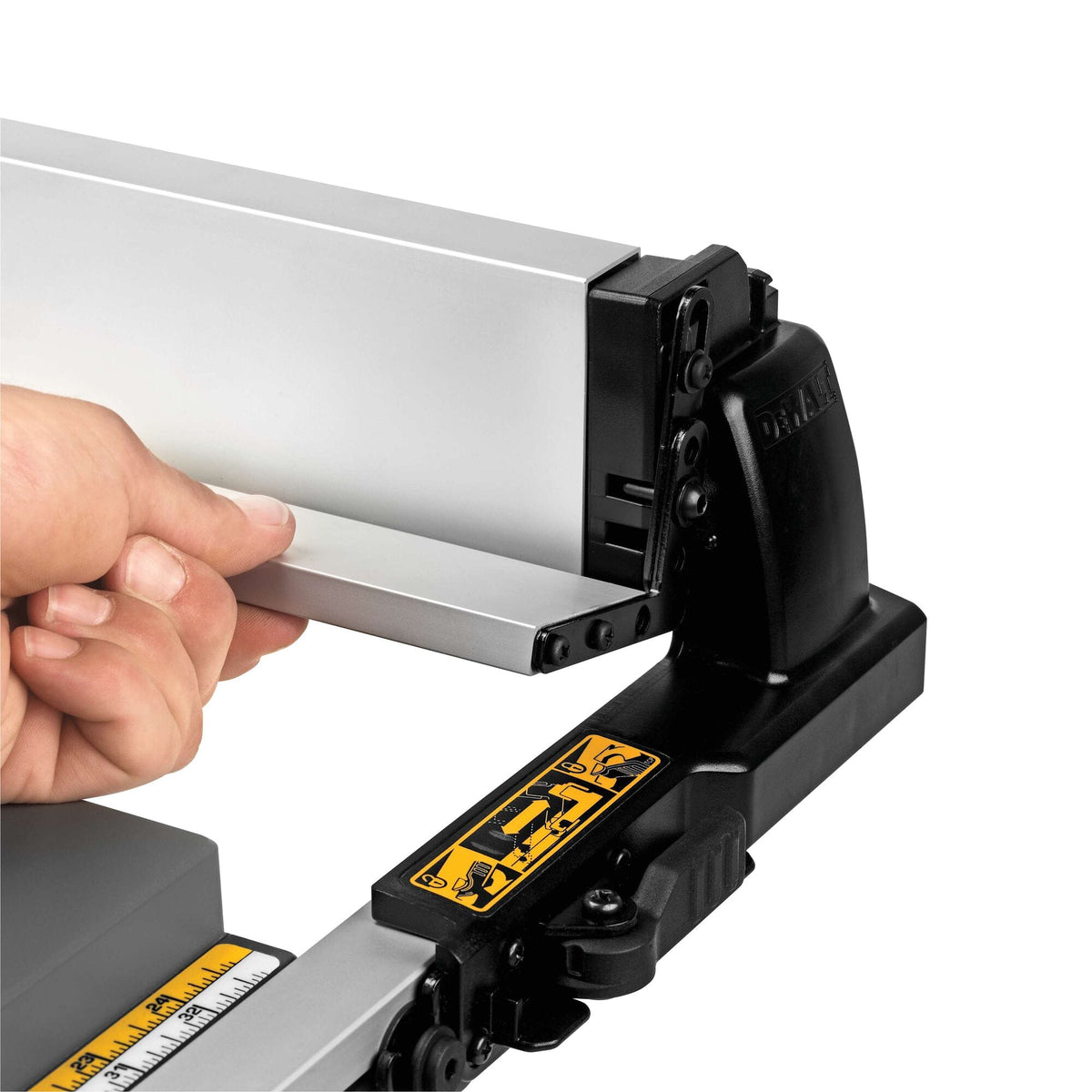 Hand extending the narrow rip flip-over fence support on the DeWalt DWE7491RS table saw for cutting thin wood strips.