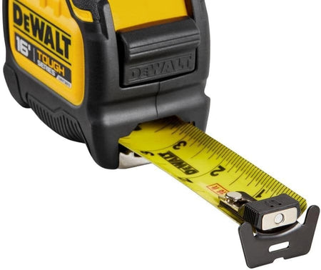 Close-up detail of the tape measure blade tip showing the magnetic end hook, the Rip-Shield clear coating, and high-contrast black measurement markings on yellow steel.