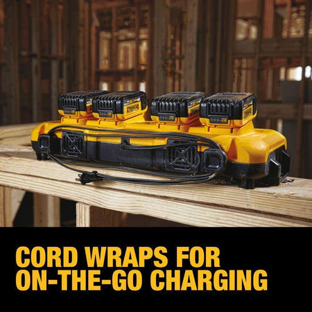 A Dewalt DCB104 4-port rapid charger shown in a workshop setting with four batteries attached and the power cord neatly organized using the built-in cord wraps, labeled Cord Wraps for On-The-Go Charging.