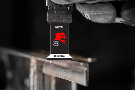Action shot of a Diablo Steel Demon bi-metal oscillating multi-tool blade performing a precise plunge cut through a thick metal structural beam.