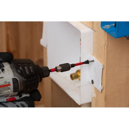 An impact driver using a Diablo Phillips bit to fasten a screw into a white electrical box bracket mounted on a wooden stud