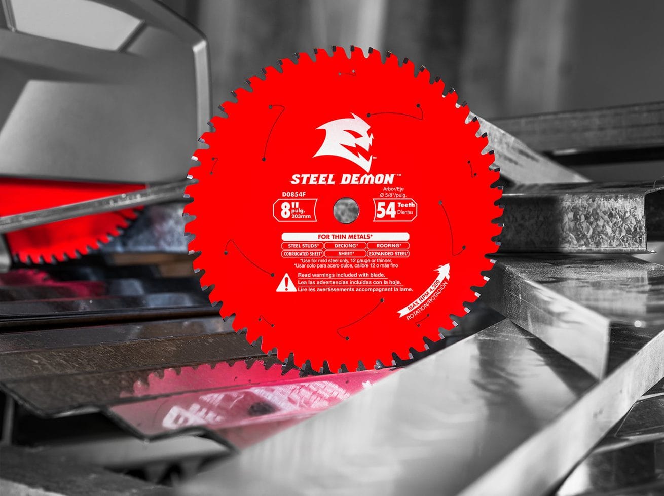 Mounted Diablo Steel Demon D0854F saw blade cutting metal; red blade labeled for thin ferrous metals with safety warnings.