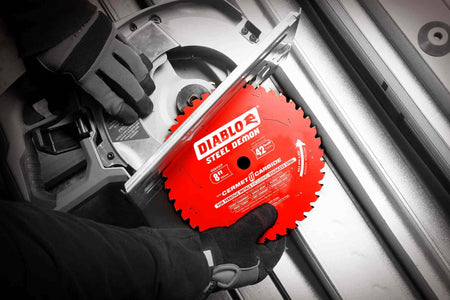 Gloved hands install the red Diablo Steel Demon Cermet II saw blade onto a circular saw.
