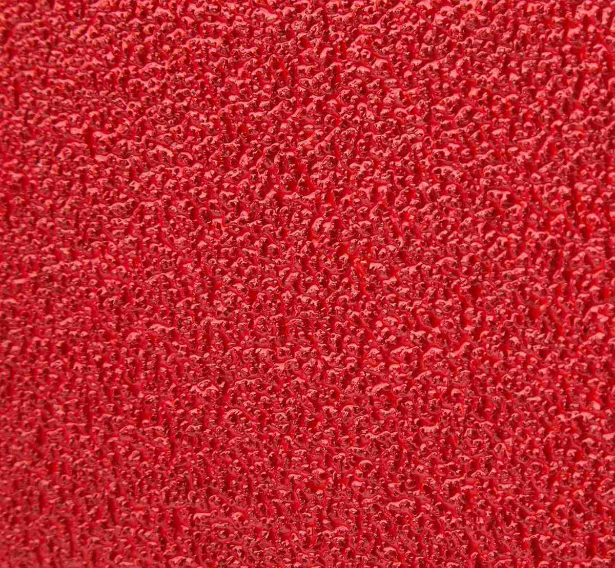 Macro close-up of the Diablo 36 grit zirconium abrasive grain showing the ultra-coarse texture designed for rapid material removal and Clog-SHIELD loading resistance.