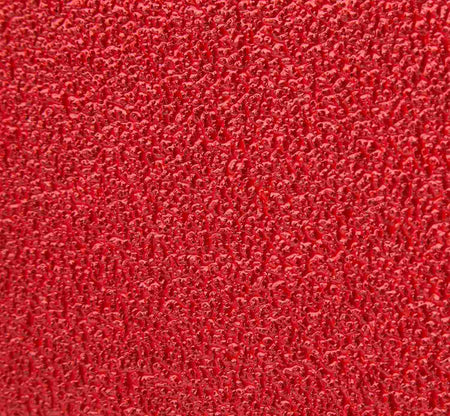 Macro close-up of the Diablo 36 grit zirconium abrasive grain showing the ultra-coarse texture designed for rapid material removal and Clog-SHIELD loading resistance.