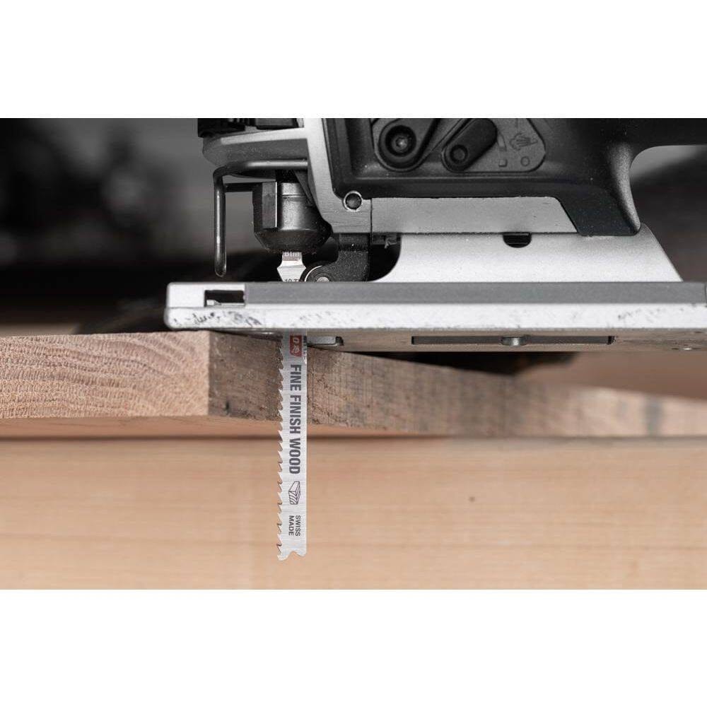 Action shot of a Diablo fine finish wood jig saw blade performing a clean, splinter-free plunge cut through a thick piece of finished lumber.