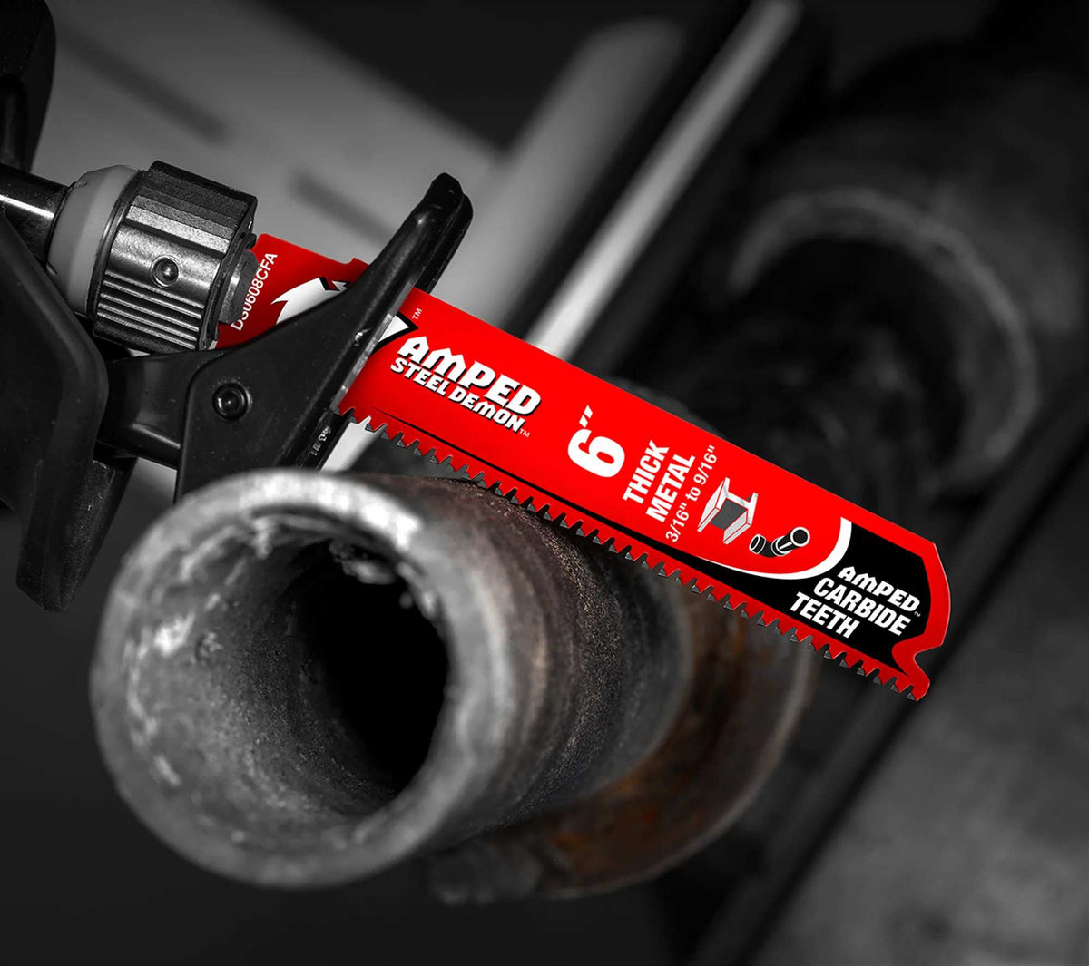 An action photograph of a 6 inch Diablo AMPED Steel Demon carbide blade in a reciprocating saw cutting through a thick-walled metal pipe, demonstrating the blade's industrial performance and heat resistance in heavy-duty fabrication.
