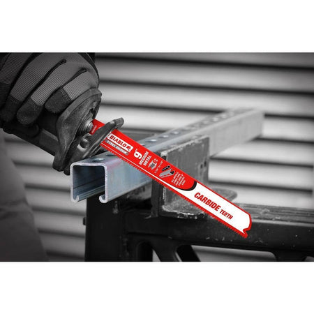 A close-up action photograph of a Diablo Steel Demon carbide blade in a reciprocating saw cutting through industrial metal unistrut, showcasing the blade's precision and ability to produce clean cuts in thick metal.