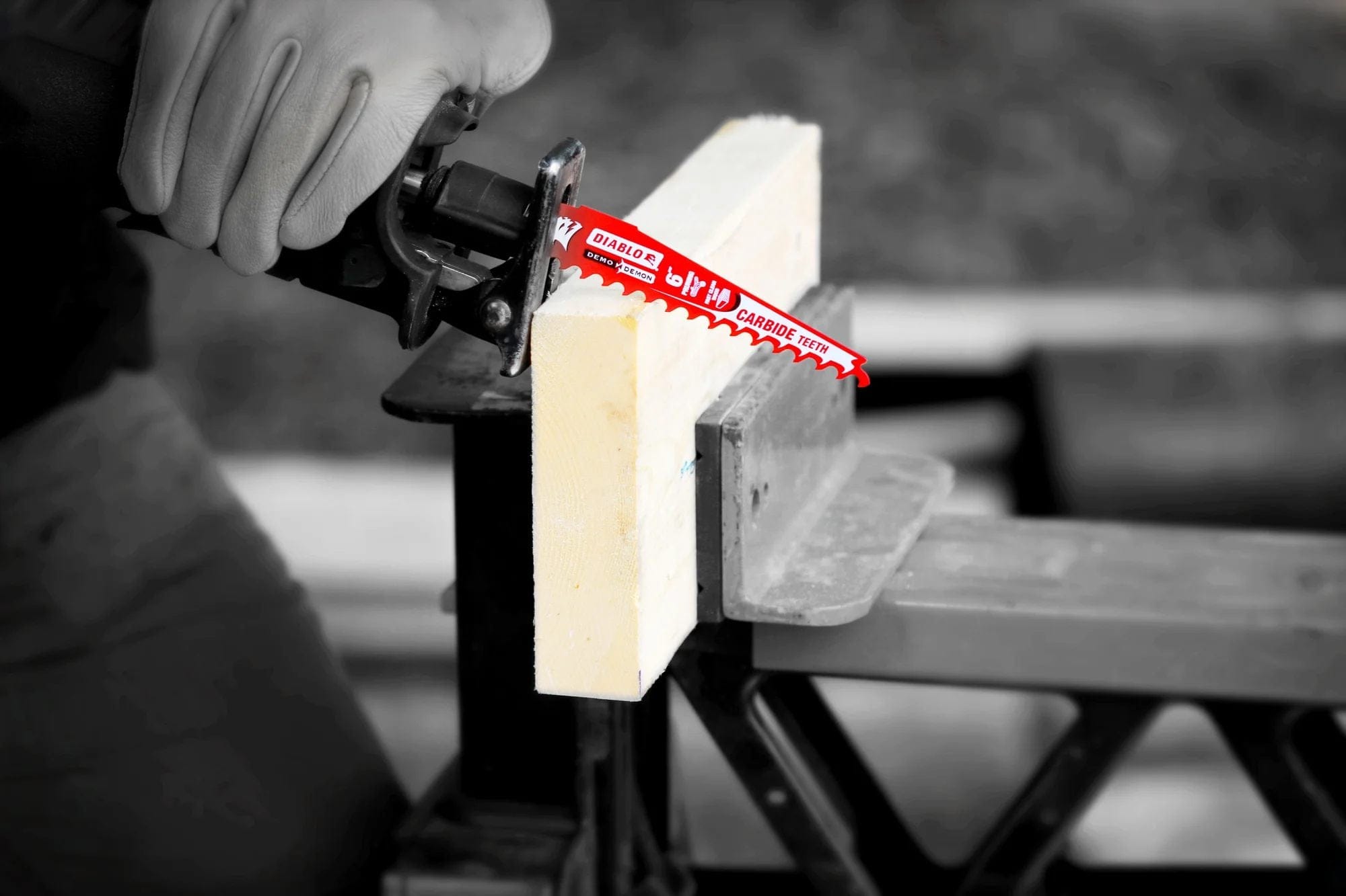 A close-up action shot of the 12 inch Diablo Demo Demon blade cutting through a clean wooden beam held in a vise, showcasing the precision and reduced vibration of the strengthened oversized blade body.