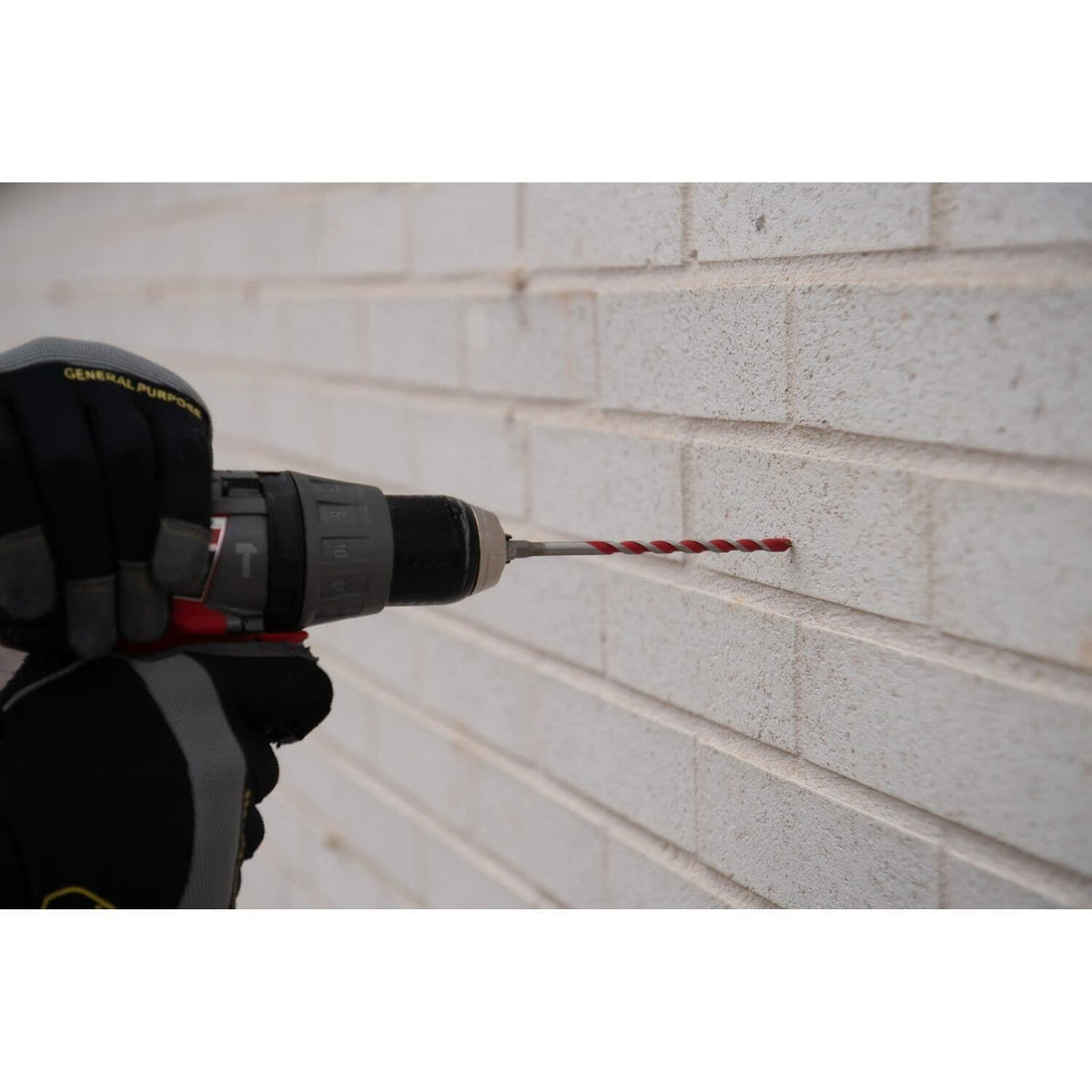 Drill bit being used on a brick wall