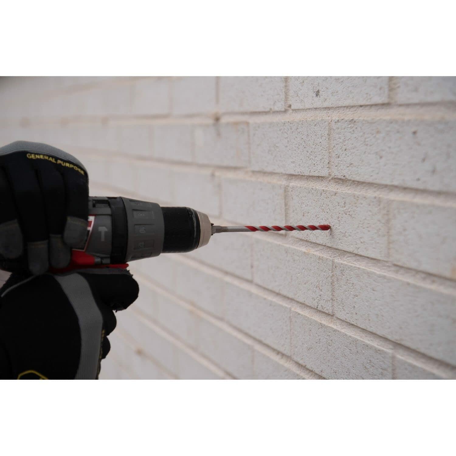 Drill bit being used on a brick wall