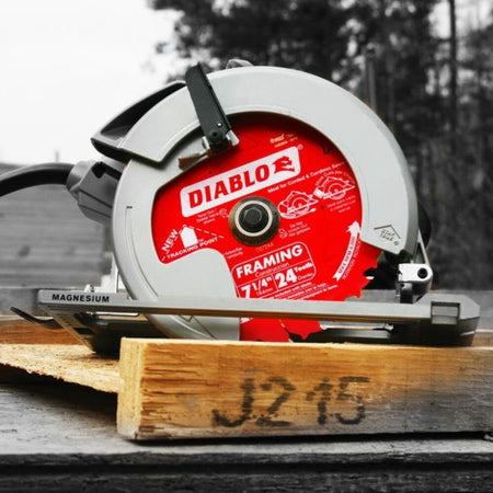 Diablo circular saw with red 7-1/4" blade embedded in wood, labeled for framing with 24 carbide-tipped teeth and tracking point design.