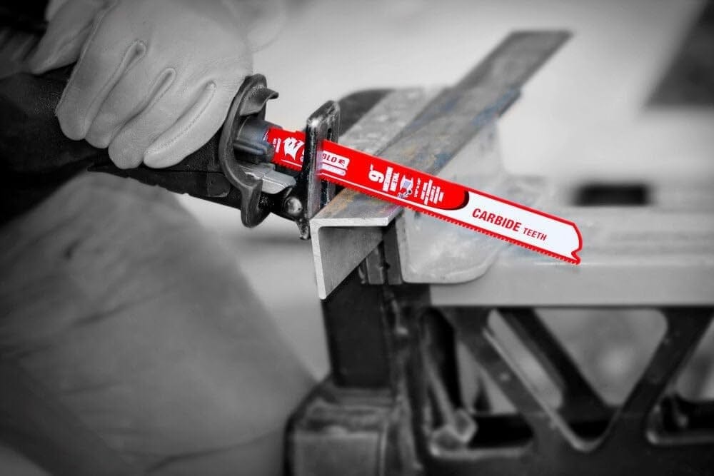 Action shot of a worker wearing gloves using the blade to cut through a thick metal angle iron.