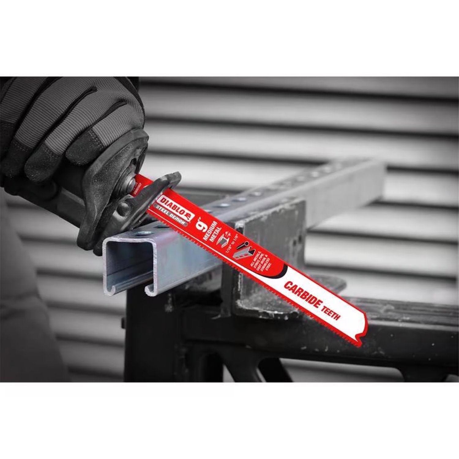 Action shot of the red reciprocating saw blade cutting through a metal strut channel.