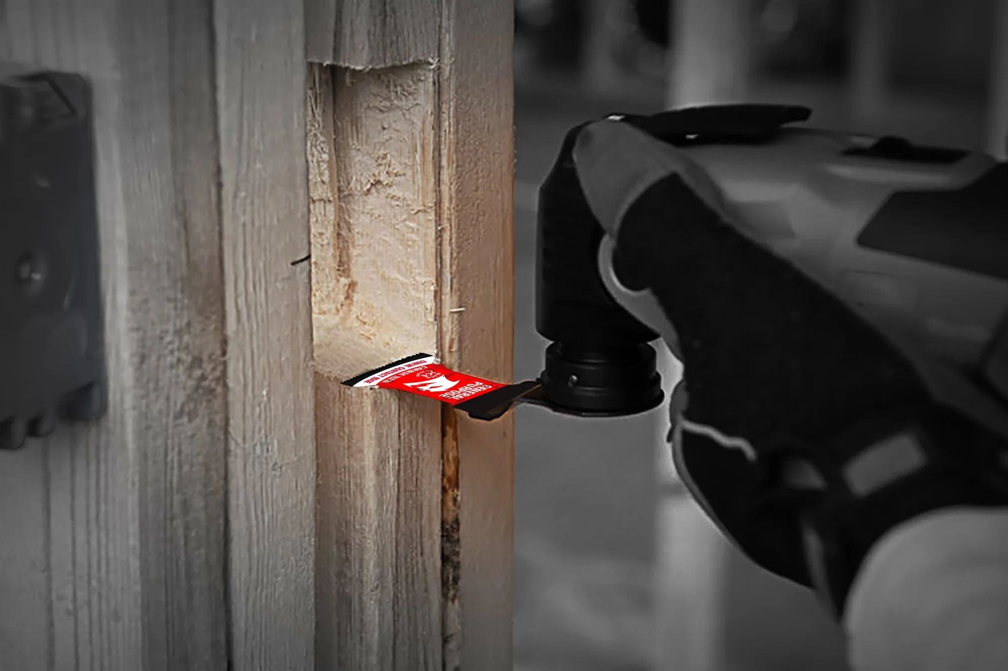 A close-up action photograph of a Diablo carbide teeth oscillating blade performing a plunge cut into a wooden stud.