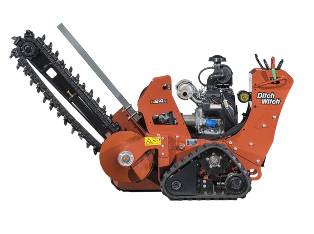 Ditch Witch C24X trencher positioned for operation, highlighting rotating chain boom, compact frame, rubber tracks, and control panel. Branding and model number clearly marked, suitable for precise trenching in construction and utility installations.