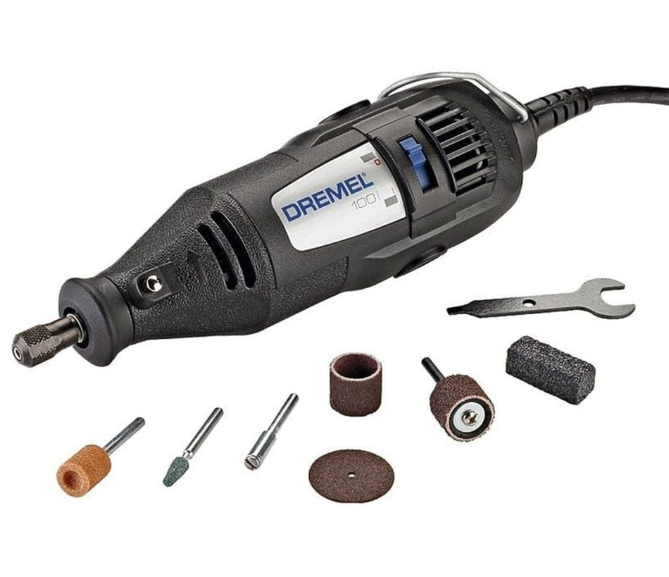 A studio shot of the Dremel 100 Series corded rotary tool, shown with its 7 assorted accessories and the collet wrench on a white background.