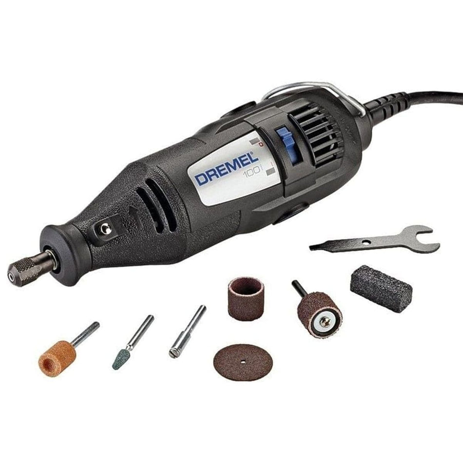 A studio shot of the Dremel 100 Series corded rotary tool, shown with its 7 assorted accessories and the collet wrench on a white background.