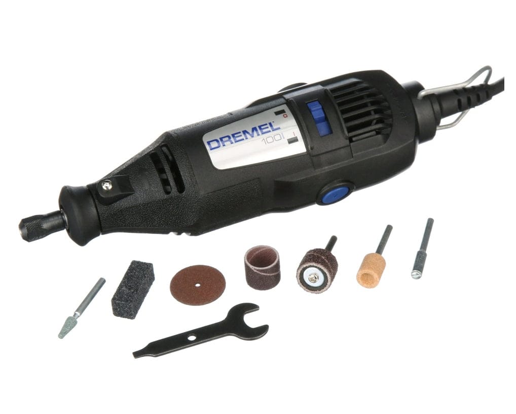 A studio shot of the Dremel 100 Series corded rotary tool, shown from a high angle with its 7 assorted accessories and the collet wrench laid out.