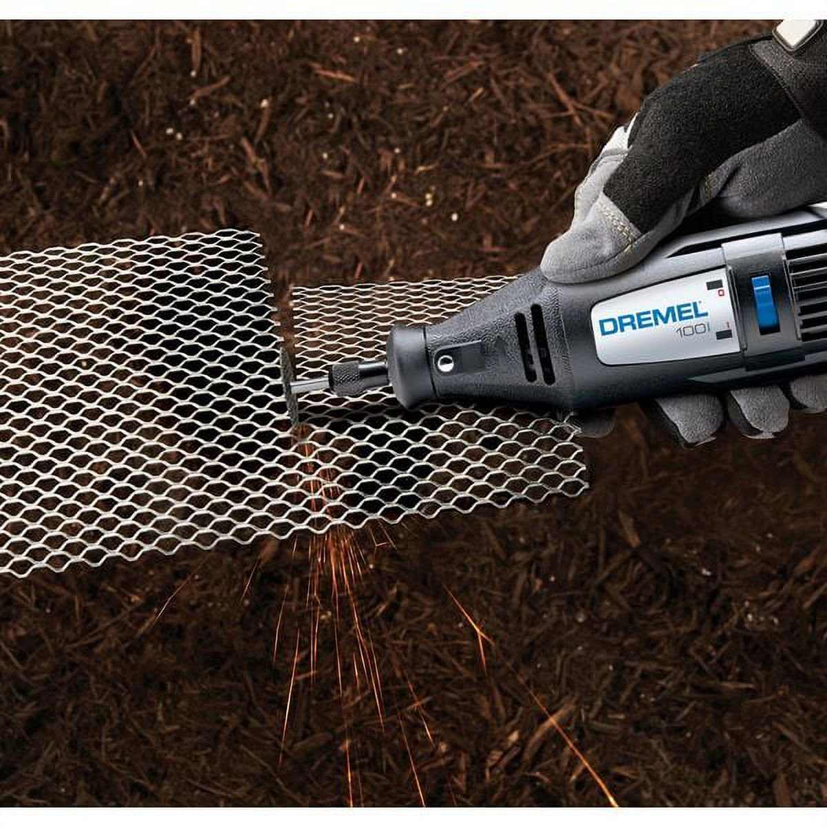 A gloved hand uses the Dremel 100 rotary tool with a cut-off wheel to cut a piece of wire mesh, creating a small shower of sparks.