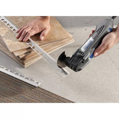 An action shot of the Dremel Multi-Max MM40 tool being used to cut a piece of metal tile trim.