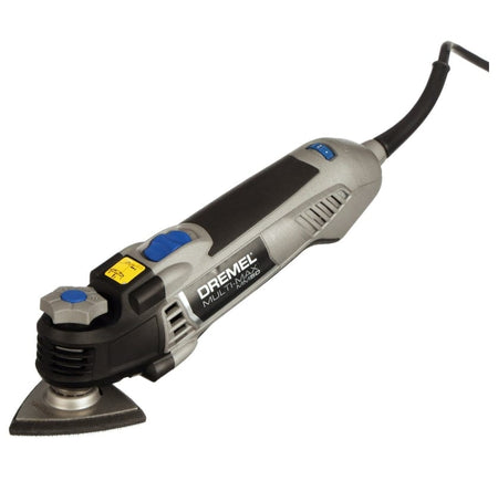 A studio shot of the Dremel Multi-Max MM50 5.0 amp oscillating tool with the triangular sanding pad and a sheet of sandpaper attached.