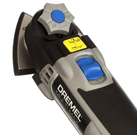 A close-up of the front end of the Dremel Multi-Max MM50, showing the blue variable speed dial, the on/off switch, and the tool-less accessory change knob.