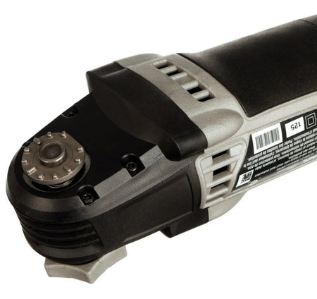 A close-up of the accessory interface on the Dremel Multi-Max MM50, showing the tool-less mechanism without a blade attached.