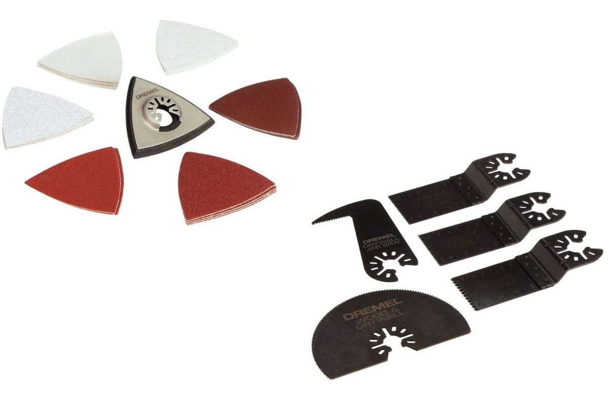 All of the cutting and sanding accessories from the Dremel MM50-01 kit laid out, including a sanding pad, sandpaper, a jab saw blade, a half-moon blade, and bi-metal blades.