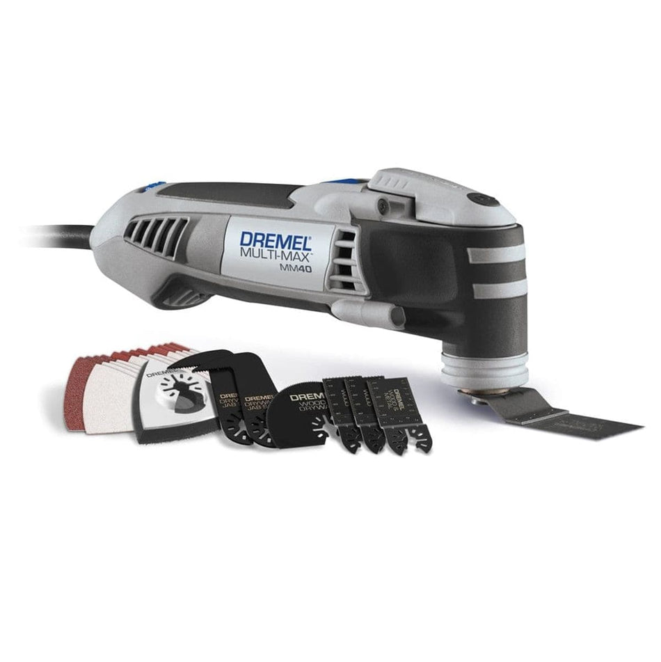 A studio product shot of the Dremel Multi-Max MM40 corded oscillating multi-tool shown with a pre-attached wood cutting blade and its 31-piece accessory kit, including various sanding sheets and specialized cutting blades for DIY projects.
