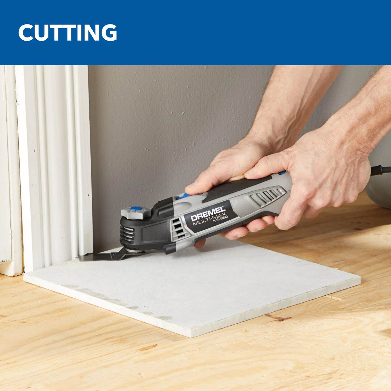 Action shot demonstrating the Dremel MM50 performing a flush cut against a floor surface to trim a door jamb, highlighting the benefit of the tool's angled body design.