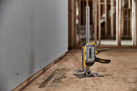 DeWalt DWHT83550 ToughSeries construction jack set up next to installed drywall sheet for vertical positioning.