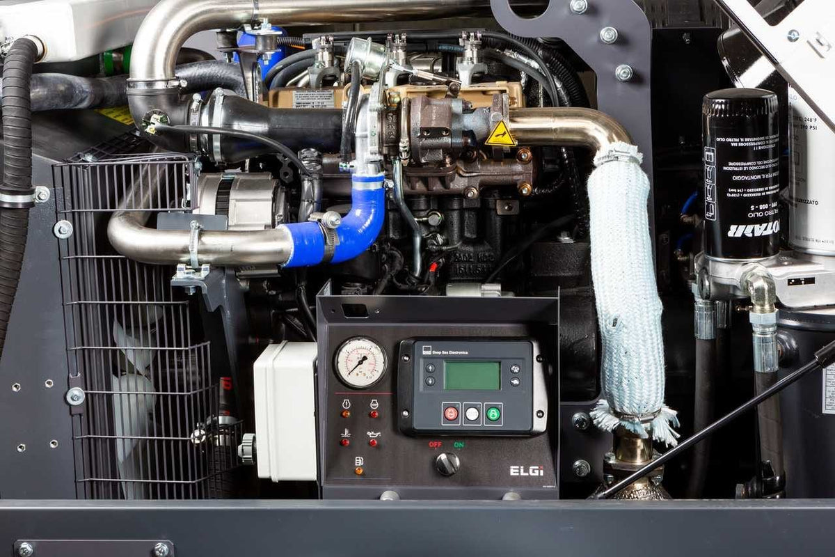 A detailed interior view of the ELGi compressor housing showcasing the Kohler diesel engine, high-quality stainless steel piping, and a digital control panel with a pressure gauge for real-time system monitoring.