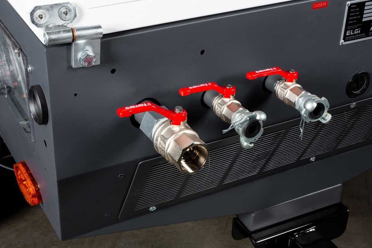 A close-up of the ELGi D185T4F outlet manifold featuring three heavy-duty air discharge valves with red handled ball valves for connecting multiple pneumatic hoses or sandblasting equipment.