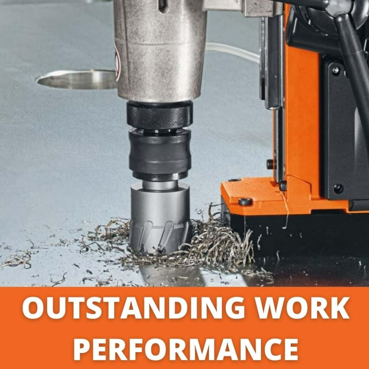 Fein magnetic drill press using an annular cutter to drill through a metal surface, with metal shavings accumulating around the cutter, emphasizing performance.