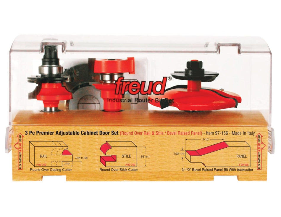 Freud 3-piece cabinet door router bit set encased in clear plastic on a wooden base. Includes Round Over Rail & Stile cutters and Bevel Raised Panel Bit with backcutter. Diagrams and labels explain each cutter’s function.