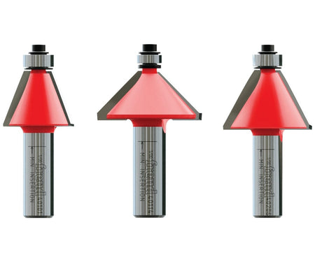 Close-up of three Freud chamfer router bits with red-coated cutting heads and metal shanks. Each bit includes a guide bearing and angled edge for creating beveled profiles on wood surfaces
