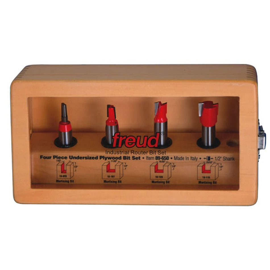 Freud 4-piece undersized plywood router bit set displayed in a wooden case with transparent front. Includes four labeled mortising bits sized for plywood: 15/32", 23/32", 31/64", and 31/32", mounted vertically.