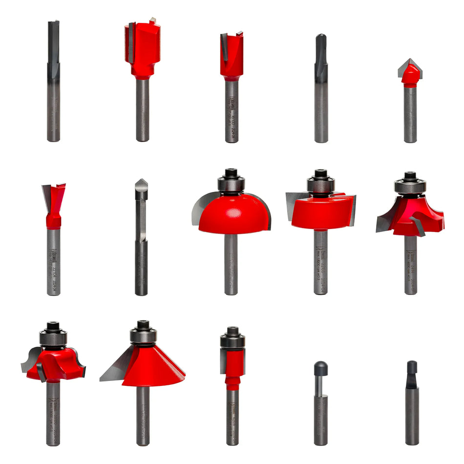 Image of 15 Freud router bits arranged in a grid. Each bit has a distinct cutting profile, with red carbide tips and metal shanks. Some bits include ball bearings for guided cuts. Designed for shaping, trimming, and grooving wood.