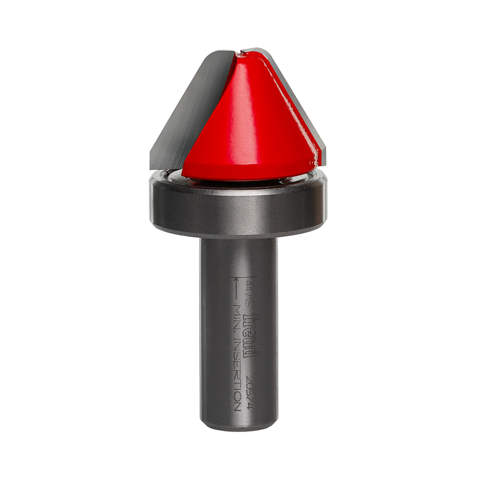 Studio product view of the Freud 20-574 router bit, featuring a 1/2 inch silver shank, a top-mounted ball bearing guide, and a red Perma-SHIELD coated cutting head with angled sides and a flattened tip.