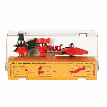 The Freud 97-154 3-piece router bit set in its clear case, showing the rail, stile, and ogee panel bits, with diagrams of the round over and ogee profiles.